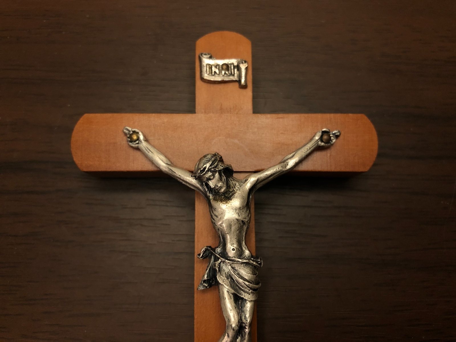 a crucifix on a wooden wall with a cross on it
